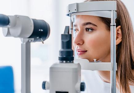 A woman with vision insurance in Idaho is getting an eye exam.