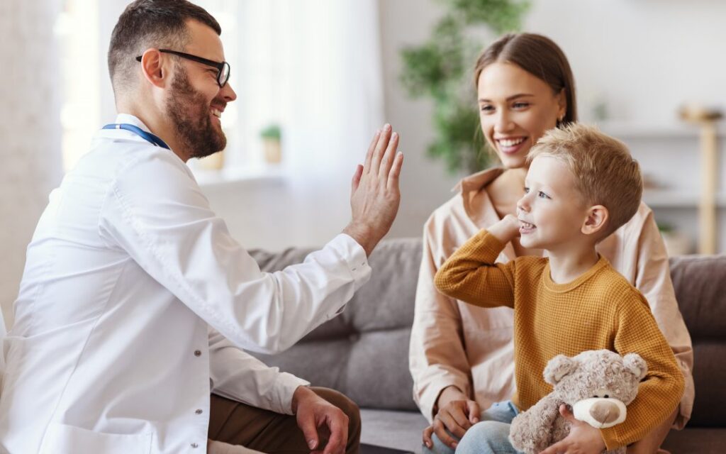 A doctor meeting with a mother and her child.